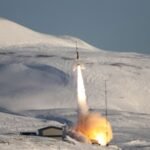 A rocket takes off from a field of ice and snow.