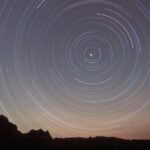 A time-lapse photo of the night sky over Coyote Buttes, Ariz., shows stars leaving circular trails around a bright point in the middle, which is the North Star.